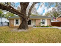 Charming brick home featuring a mature tree, front lawn, and neutral trim accents at 1162 South Shadow Dr, Mount Pleasant, SC 29464