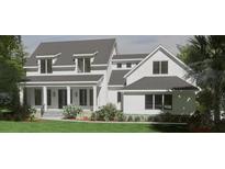Charming two-story modern farmhouse with a covered porch and a metal roof at 118 Peninsula Dr, Ravenel, SC 29470