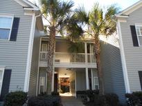 Exterior view of condo with palm trees and entry to units 1201 and 1205 at 1204 Grove Park Dr, Charleston, SC 29414