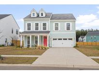 Charming two-story home with a bright red door and dormer windows at 1420 Homecoming Blvd, Ravenel, SC 29470