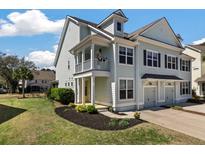 Charming two-story home featuring a porch, complemented by manicured landscaping and a private entrance at 1457 Red Tide Rd, Mount Pleasant, SC 29466