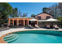 Inviting backyard pool with tanning ledge and patio with lounge chairs and umbrellas at 2014 Ion Ave, Sullivans Island, SC 29482