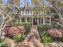 Charming two-story home with a manicured lawn and a grand staircase leading to a welcoming front porch at 2292 Beckenham Dr, Mount Pleasant, SC 29466