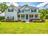 Charming two-story home with manicured lawn and inviting front porch at 5556 Indigo Fields Blvd, North Charleston, SC 29418