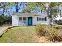 Charming single-story home featuring a bright blue front door and freshly painted white siding at 5801 Chaucer Dr, Hanahan, SC 29410
