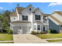 Charming two-story home with a two-car garage, a balcony, and a well-manicured front yard at 6005 Coral Berry Rd, Hanahan, SC 29410