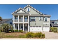 Charming two-story home with a double front porch and manicured landscaping at 1166 Elliotts Cut Dr, Charleston, SC 29412