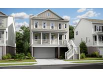 Charming two-story home with a welcoming front porch and a convenient ground-level garage at 1683 Cultivation Ln # 460, Mount Pleasant, SC 29466
