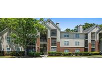 Attractive multi-story condo building with brick accents and mature landscaping at 2011 N Highway 17 # 1100I, Mount Pleasant, SC 29466