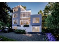 Beautiful modern home with large windows, striking architecture and landscaped surroundings at 304 Carolina Blvd, Isle of Palms, SC 29451