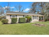Charming single-story home with a well-manicured lawn and lovely landscaping at 3564 Blanding Dr, Johns Island, SC 29455