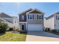 Two-story home features a gray exterior, black shutters, and a front-facing two-car garage at 4809 Bushel Rd, Ladson, SC 29456