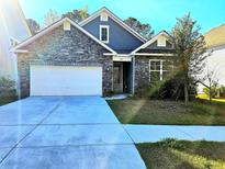 Charming single-Gathering home with stone accents, a two-car garage, and a well-maintained lawn and landscape at 482 Oak View Way, Summerville, SC 29483