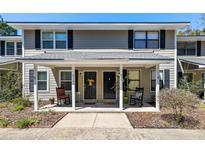 Inviting townhome exterior with a shared front porch, rocking chairs, and attractive curb appeal at 915 Dills Bluff Rd # 39, Charleston, SC 29412