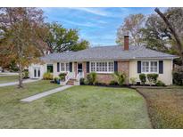 Charming brick home with manicured lawn, white shutters, and inviting front porch, showing curb appeal at 105 Chadwick Dr, Charleston, SC 29407