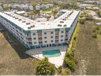 Coastal condo complex featuring a private pool and balconies overlooking lush marshlands at 116 Bay Creek Villa, Edisto Beach, SC 29438