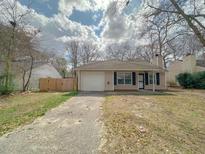 Charming single-story home with a front yard, driveway, and attached garage under a cloudy sky at 154 Tabby Creek Cir, Summerville, SC 29486