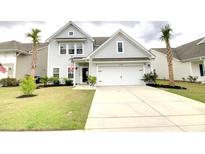 Charming two-story home with a well-manicured lawn and attached two-car garage at 1540 Dawn Mist Way, Charleston, SC 29414