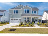 Charming two-story home with a manicured lawn, two-car garage, and welcoming front porch perfect for relaxation at 181 Ashworth Dr, Summerville, SC 29486