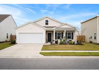 Inviting single-story home features a covered porch, well-maintained landscaping, and two-car garage at 226 Clydesdale Cir, Summerville, SC 29486