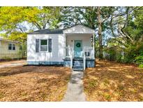 Charming single-story home with a welcoming blue door and beautiful, mature landscaping at 2604 Ferrara Dr, North Charleston, SC 29405