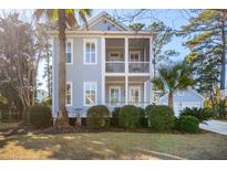 Charming two-story home with a double porch and lush landscaping for enhanced curb appeal at 307 Shoals Dr, Mount Pleasant, SC 29464