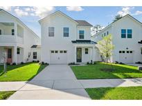 Charming two-story home with a well-manicured lawn, driveway, and attached one car garage at 475 Queenview Ln, Charleston, SC 29414