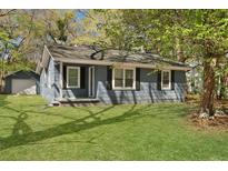 Charming home with fresh green lawn, gray siding, black shutters, and attractive curb appeal at 5729 Edison Ave, Hanahan, SC 29410