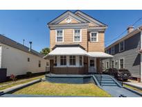 Charming two-story home with a covered porch and well-maintained front yard at 6 Carolina St, Charleston, SC 29403