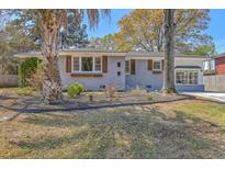 Charming single-story home with painted brick, decorative shutters, and landscaped front yard at 6009 Meadowcliff Ave, Hanahan, SC 29410