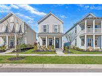 Charming home with light gray siding, a welcoming front porch, and manicured landscaping at 619 Trio Ln, Summerville, SC 29486