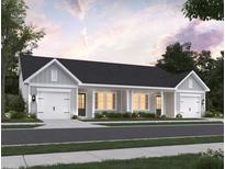 Charming duplex featuring a classic design with attached garages and a welcoming facade with manicured landscaping at 958 Dusk Dr, Summerville, SC 29486