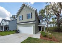Charming two-story home with a well-manicured lawn and a two-car garage in a residential neighborhood at 103 Rosa Gray Ln, Goose Creek, SC 29445