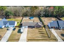 Sprawling property features an above-ground pool and charming brick home with RV parking at 112 Lois Cir, Moncks Corner, SC 29461