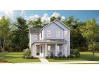 Charming two-story home with a welcoming front porch, lush lawn and classic blue siding, creating a picturesque curb appeal at 136 Maritime Way, Summerville, SC 29485
