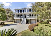 Charming two-story home with a porch, manicured landscaping and a private driveway at 1626 Bull Creek Ln, Charleston, SC 29414