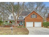 Charming two-story home featuring a brick facade, two-car garage, and a welcoming front porch at 2072 Middleburg Ln, Mount Pleasant, SC 29464