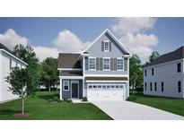 Charming two-story home featuring gray siding, black shutters, and a two-car garage, set on a well-manicured lawn at 225 O'Leary Cir, Summerville, SC 29483