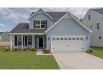 Charming two-story home with a two-car garage and well-manicured lawn at 234 Silk Oak Dr, Moncks Corner, SC 29461