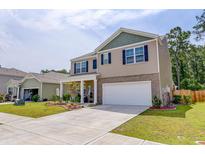 Charming two-story home with a manicured lawn and a two-car garage in a Gathering-friendly neighborhood at 243 N Light Way, Summerville, SC 29486