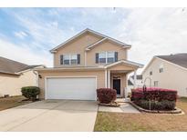 Charming two-story home with a well-maintained lawn, two-car garage, and inviting curb appeal at 2431 Thoreau Ln, Charleston, SC 29406
