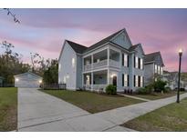 Charming two-story home boasts a double porch, complementing the home's exterior at 2837 Rutherford Way, Charleston, SC 29414