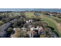 Beautiful aerial view of 3005 Ocean Villas overlooking a golf course, ponds, and the Island Club at 3005 Ocean Winds Dr, Seabrook Island, SC 29455