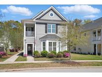 Charming two-story home with a cozy front porch and beautifully landscaped front yard at 3020 Plumier Pl, Charleston, SC 29414