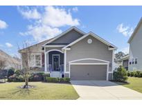Charming single-Gathering home with inviting covered entry, attached garage, and well-manicured front lawn at 345 Turnstone St, Mount Pleasant, SC 29464