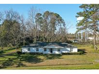 Charming single-story home featuring a classic white facade, well-maintained lawn, and mature trees at 6156 Badham Dr, Reevesville, SC 29471