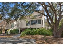 Charming home featuring lush landscaping, elevated structure, and mature trees at 740 Spinnaker Beachhouses, Seabrook Island, SC 29455