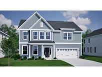 Charming two-story home with blue siding, white trim, a well-manicured lawn, and attached two-car garage at 117 Seaton St, Summerville, SC 29486