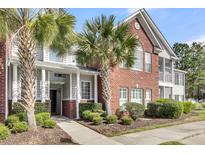 Charming condominium exterior with lush landscaping and classic brick and siding accents at 1362 Kingsford Ln, Mount Pleasant, SC 29466
