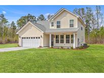 Charming two-story home with a two-car garage, a manicured lawn, and craftsman architecture at 153 Mitch Ln, Holly Hill, SC 29059